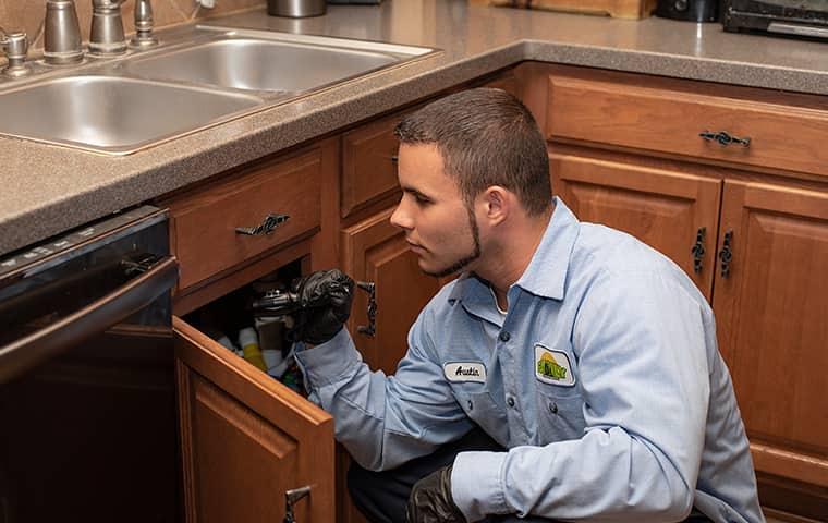 Technician checking kitchen cabinets
