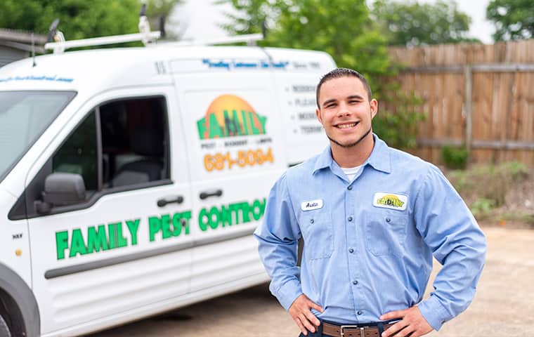 Pest technician in front of work truck